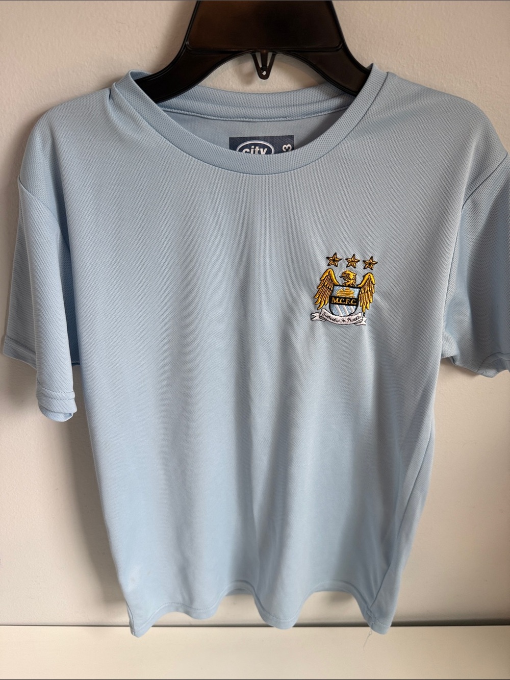 MANCHESTER CITY CHAMPIONS 14 Kids Light Blue Soccer Crest Tee